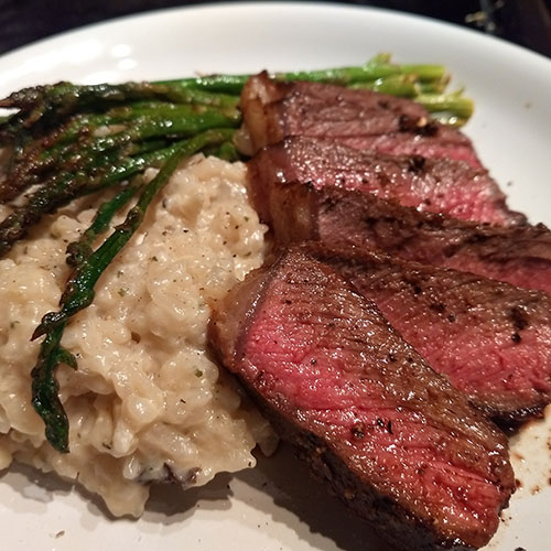 aspiring chef whips up steak and risotto